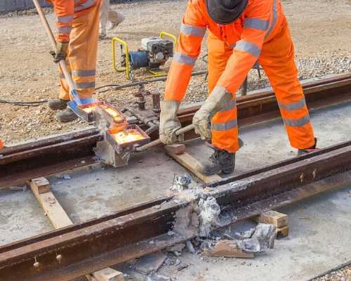 Construction workers building railroad.