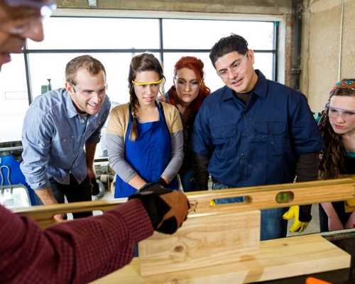 Construction Students Gathering Around Teaching Demonstration