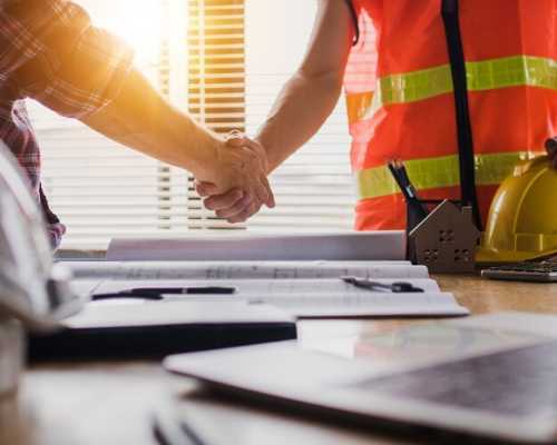 Two Construction Workers Shaking Hands