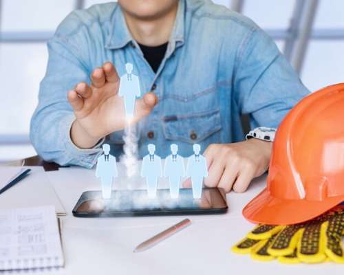 Construction worker managing HR resources on a tablet